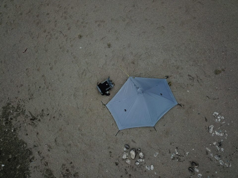 Overhead view of a gray Lunar Solo pitched on a sandy beach