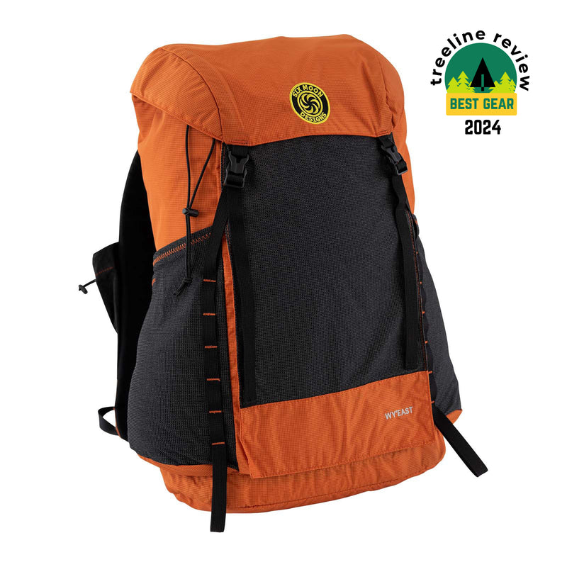 Wy'east backpack in orange with a white background.  Also showing an award from Treeline review for Best Gear 2024
