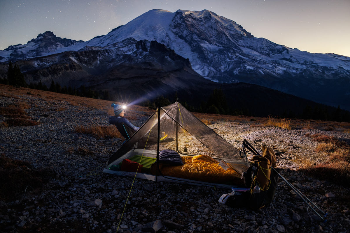 Haven tent with the doors open at dusk, sleeping bags inside, below snow-capped Mount Rainier